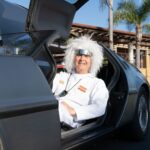 1982 DeLorean and Gordon Carpenter wearing the Doc Brown costume from the Back-To-The-Future movie.