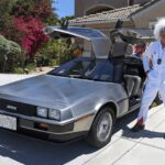 1982 DeLorean and Gordon Carpenter wearing the Doc Brown costume from the Back-To-The-Future movie.
